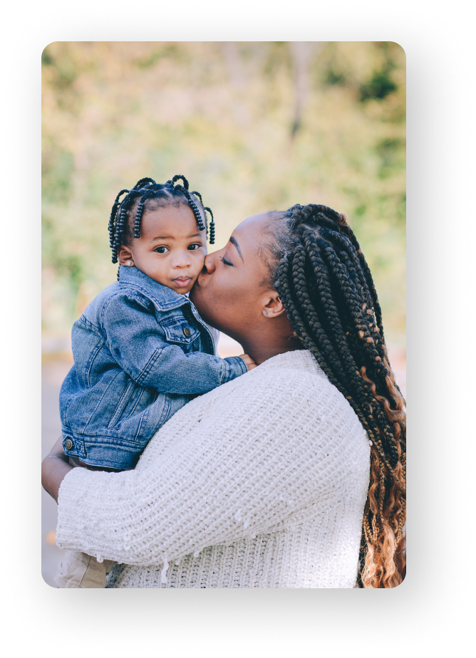 mom kissing child in her arms